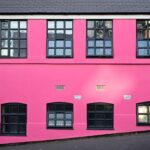 a pink building with windows